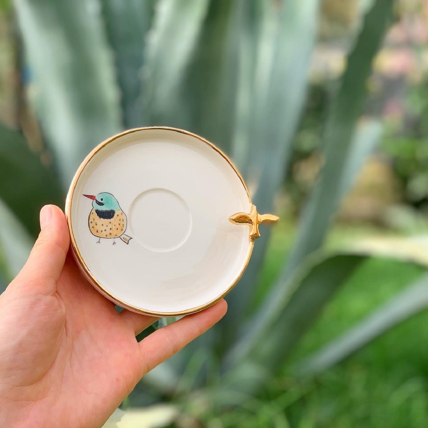Coffee saucer plate, white with gold rim and bird print, small gold cross detail