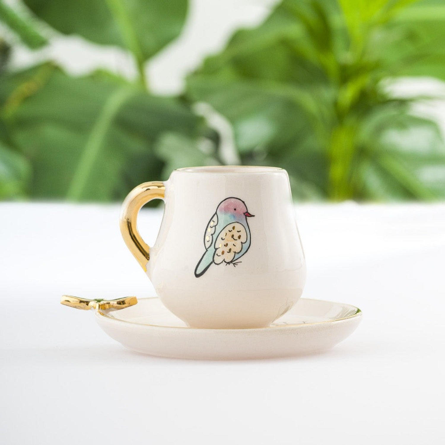 Coffee cup and saucer set, white ceramic cup with gold handle and colorful bird motif