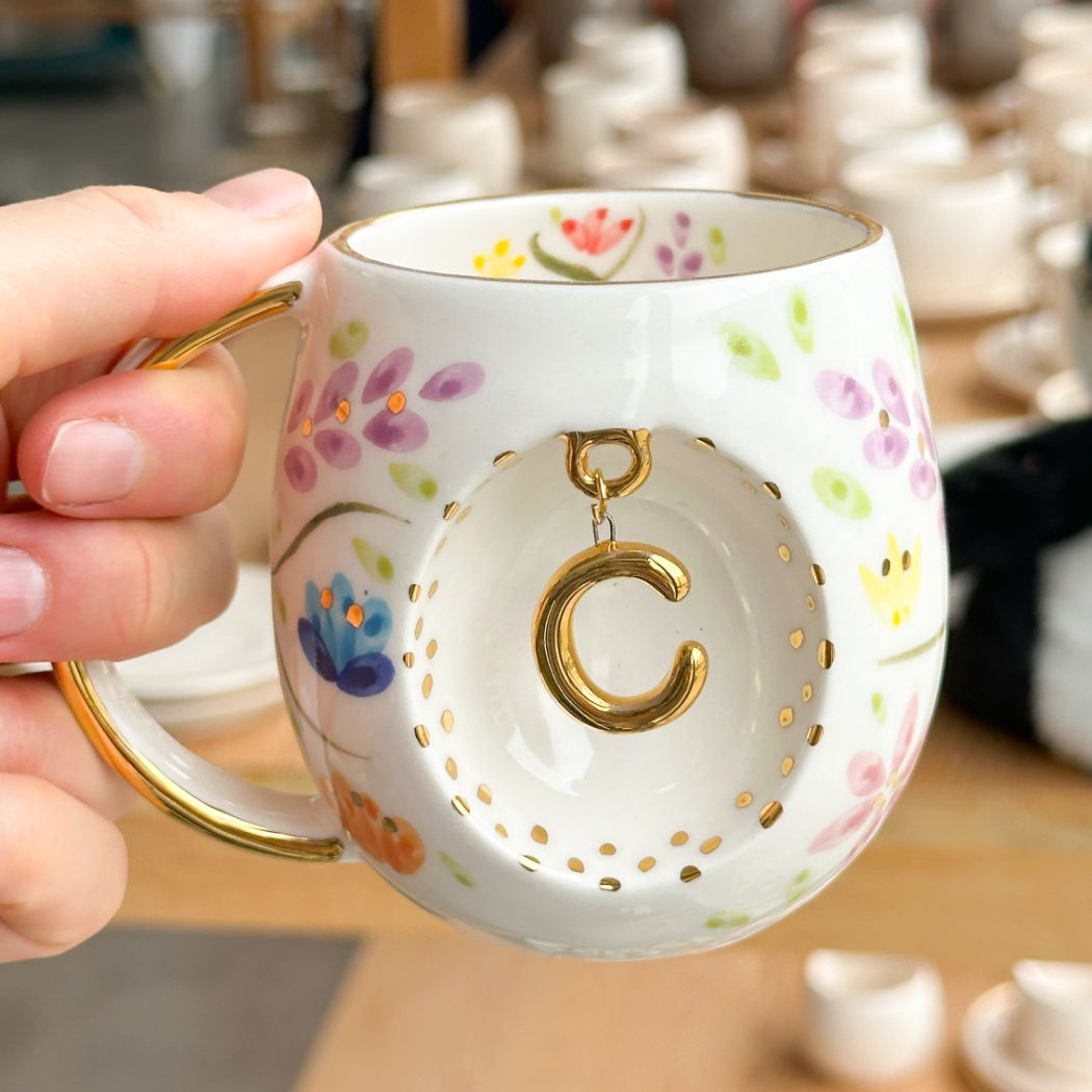 Porcelain letter mug with gold handle and gold letter C, spring floral pattern