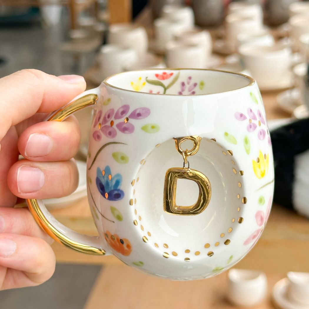 Porcelain letter mug with gold handle and gold letter D, spring floral pattern