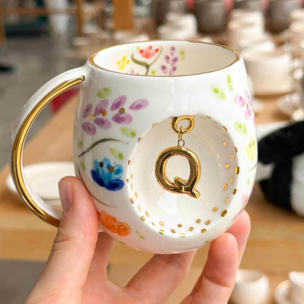 Porcelain letter mug with gold handle and Q letter charm, floral spring blossom design