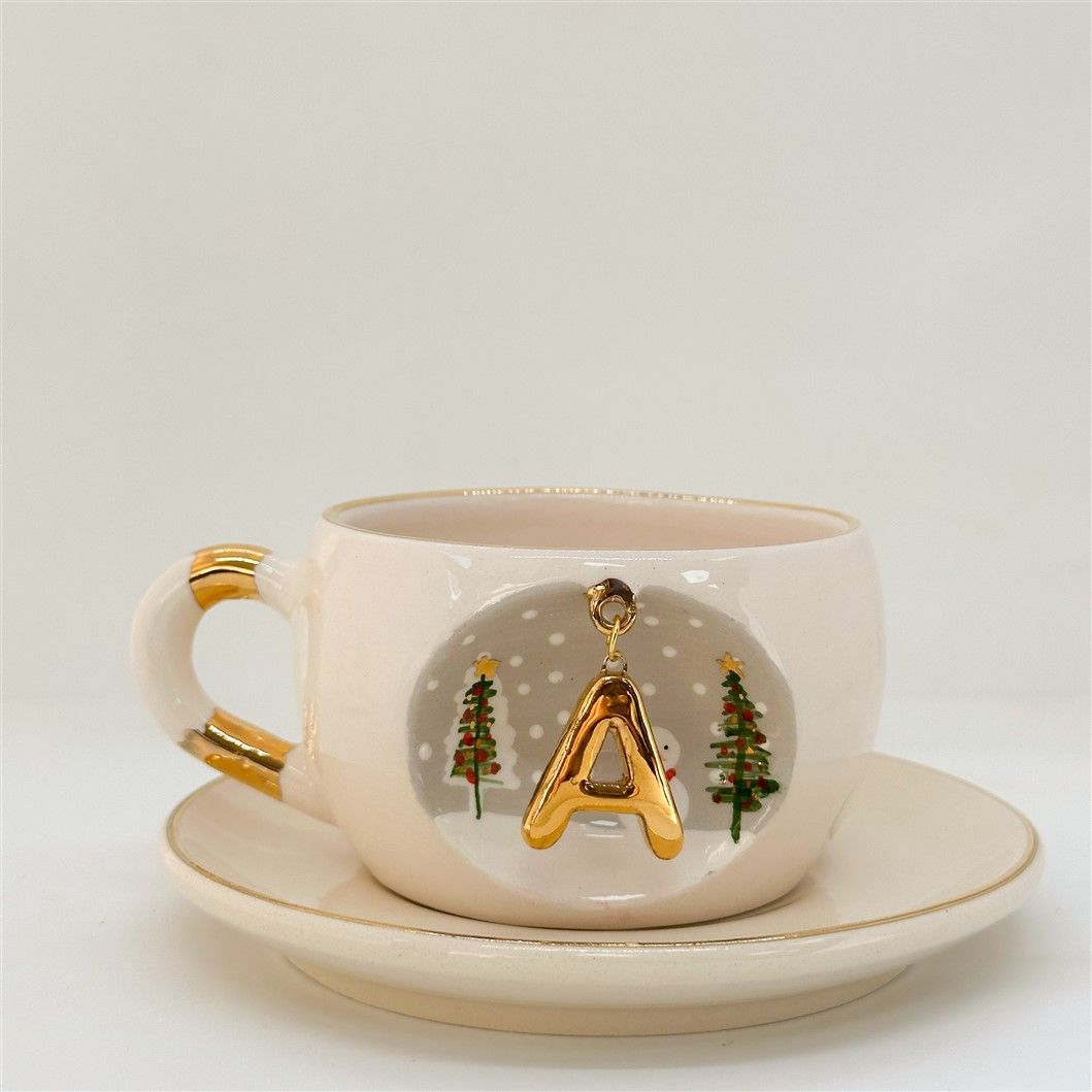 Porcelain tea cup and saucer, gold handle, letter A charm with tree accents