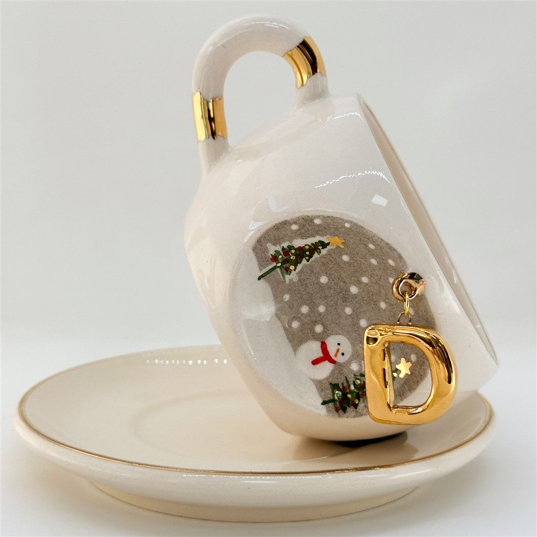 Porcelain tea cup on saucer with C letter gold charm, winter trees and snowman