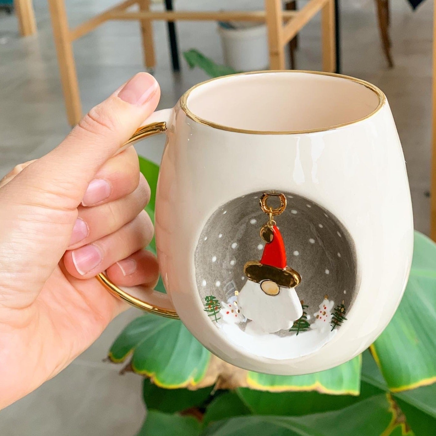 White ceramic mug with gold handle, Father Christmas ornament design on front