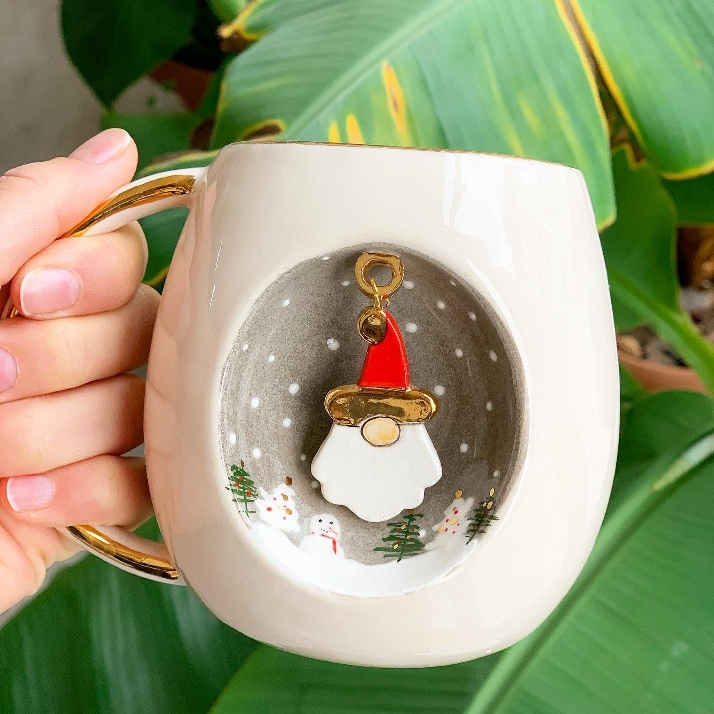 White ceramic mug with gold handle, Father Christmas graphic centered on front