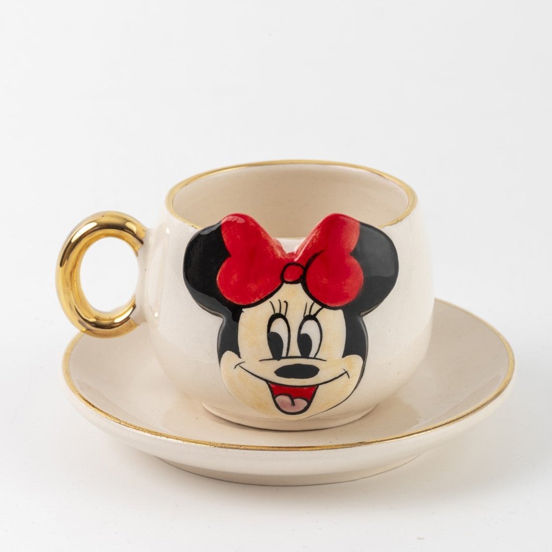 White Minnie Mouse coffee cup with gold handle, gold rim, and matching saucer