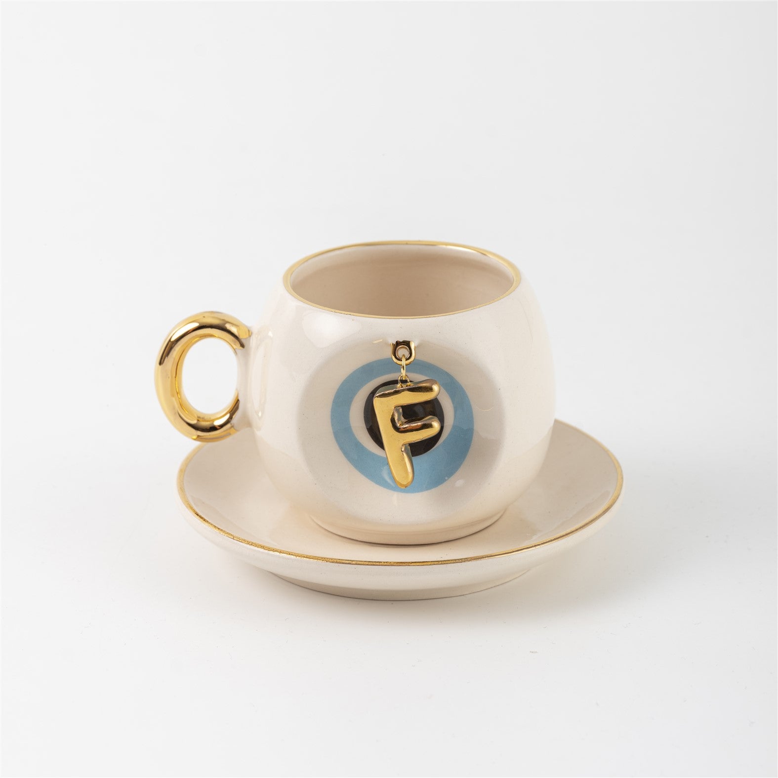 Ceramic Turkish coffee cup and saucer with gold handle, blue letter F charm