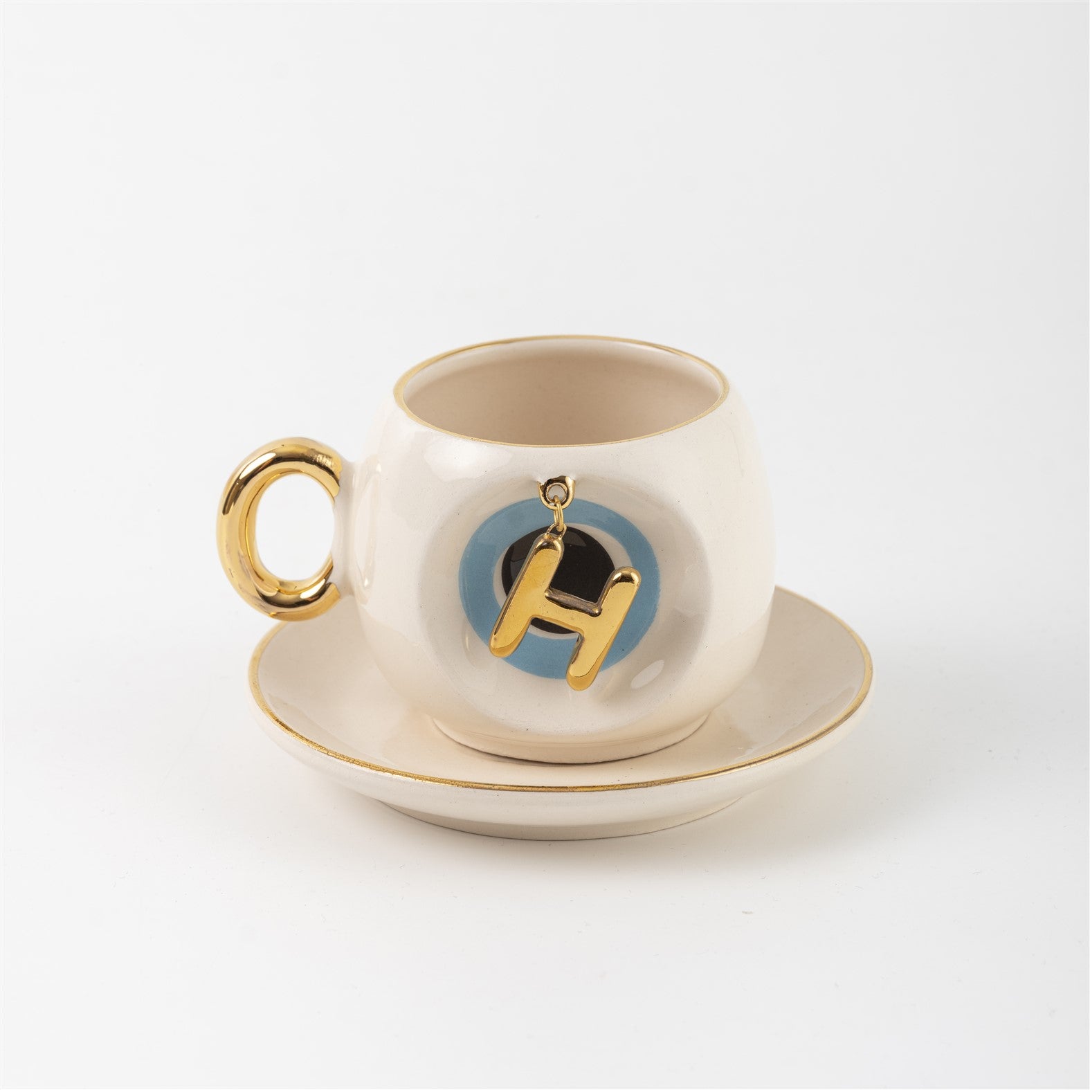 Ceramic Turkish coffee cup and saucer with gold handle, blue letter H charm