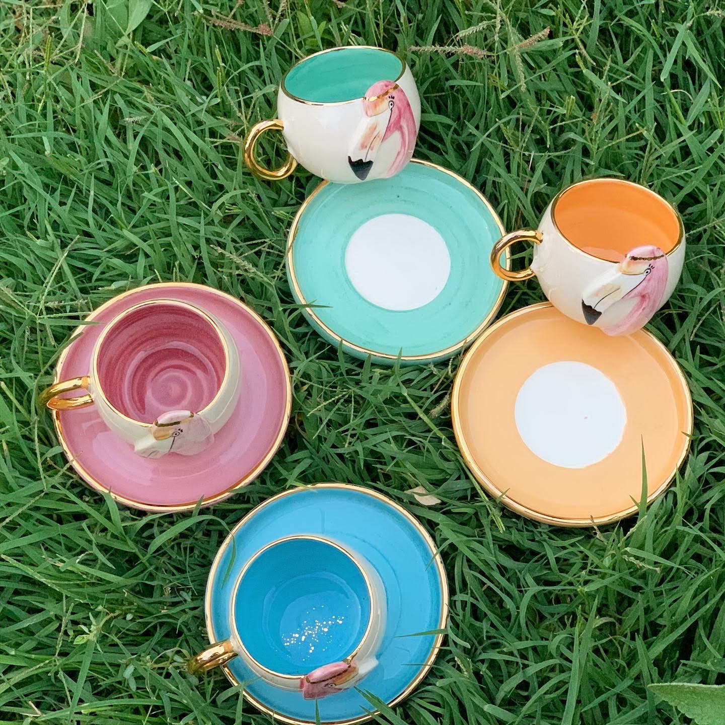Colorful flamingo coffee cup set of four with matching saucers and gold handles