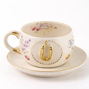 Porcelain letter mug and saucer with floral trim and gold U medallion
