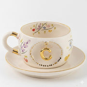 Porcelain letter mug and saucer with floral trim and gold C medallion