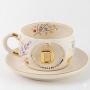 Porcelain letter mug and saucer with floral trim and gold D medallion