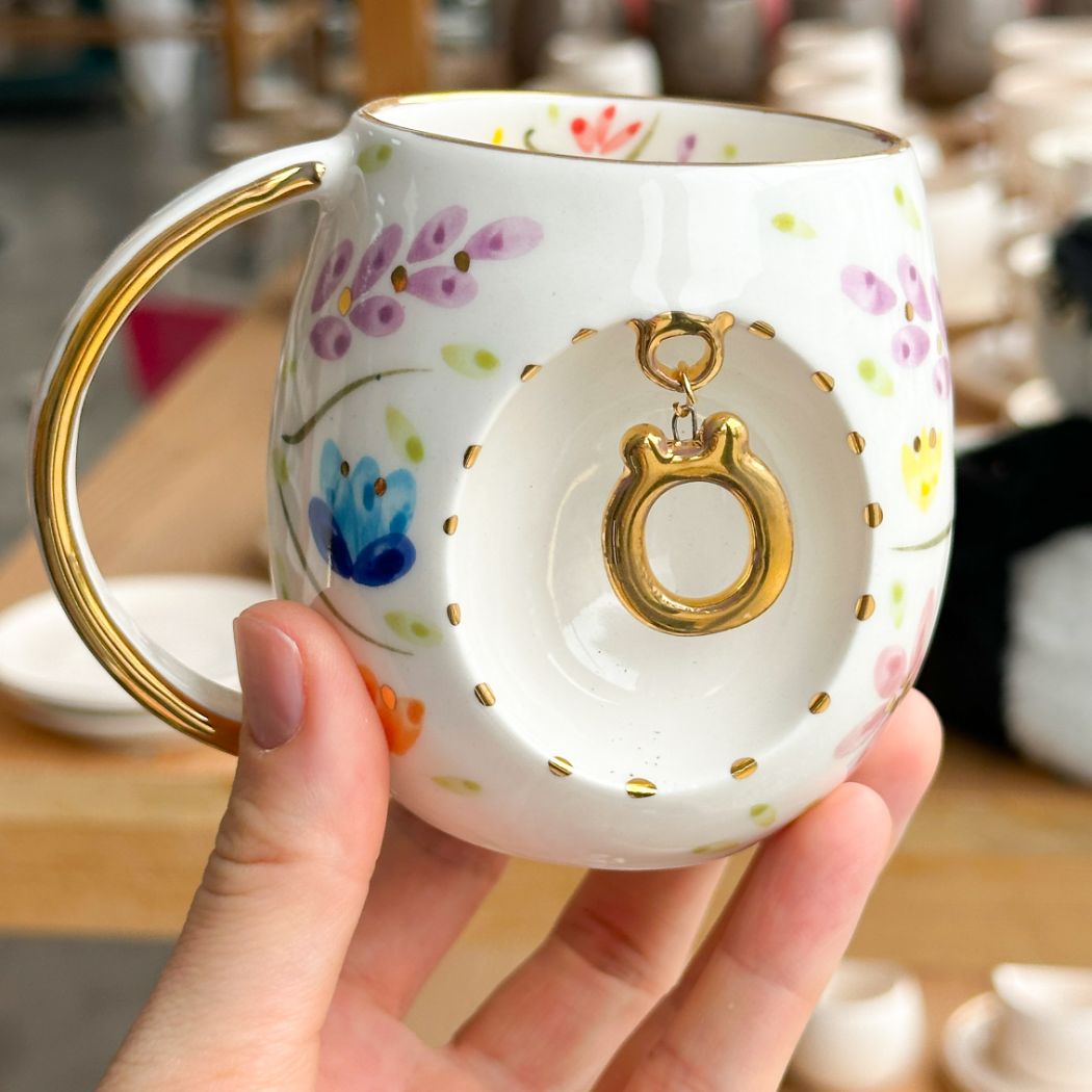 Porcelain letter mug with gold handle and gold letter O, spring floral pattern