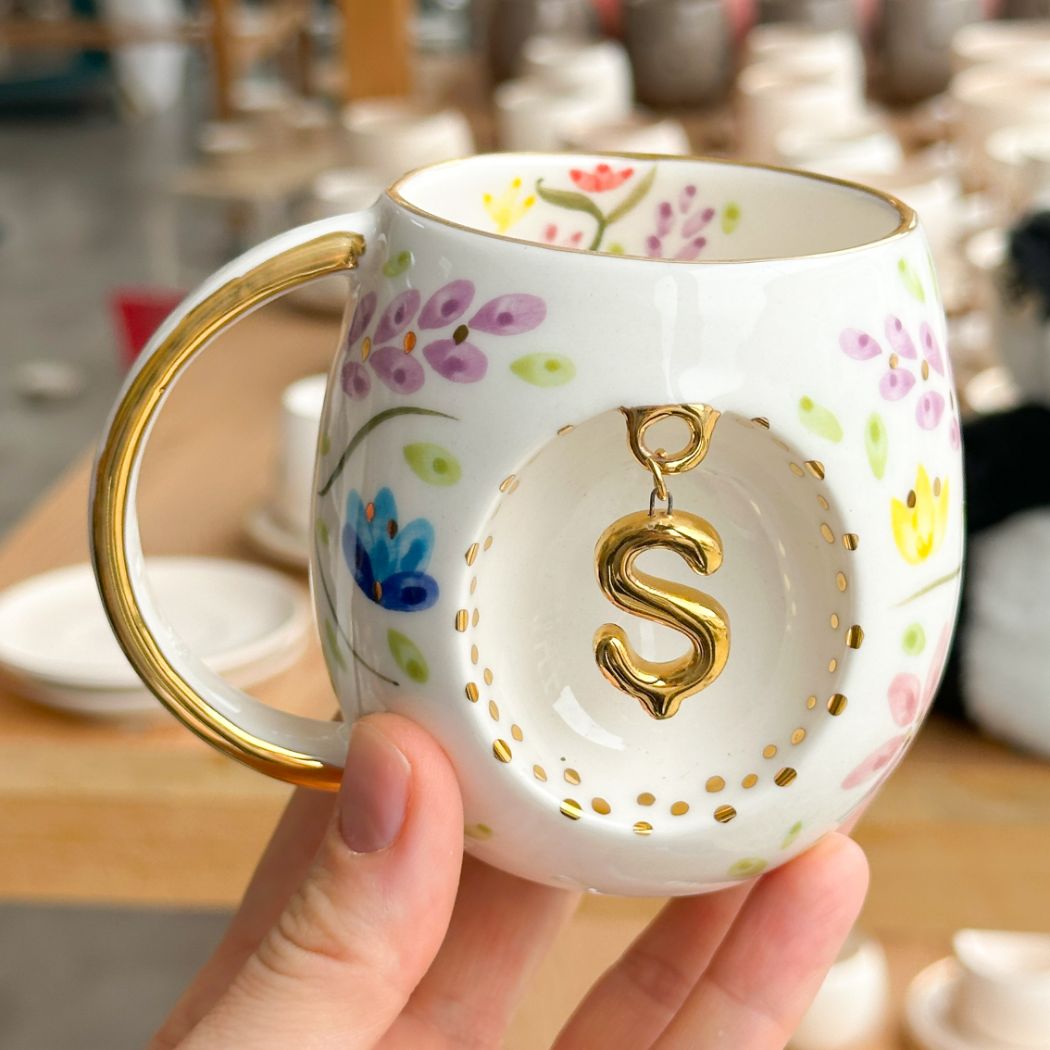 Porcelain letter mug with gold handle and gold letter S, spring floral pattern