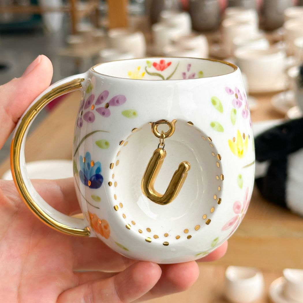 Porcelain letter mug with gold handle and gold letter U, spring floral pattern