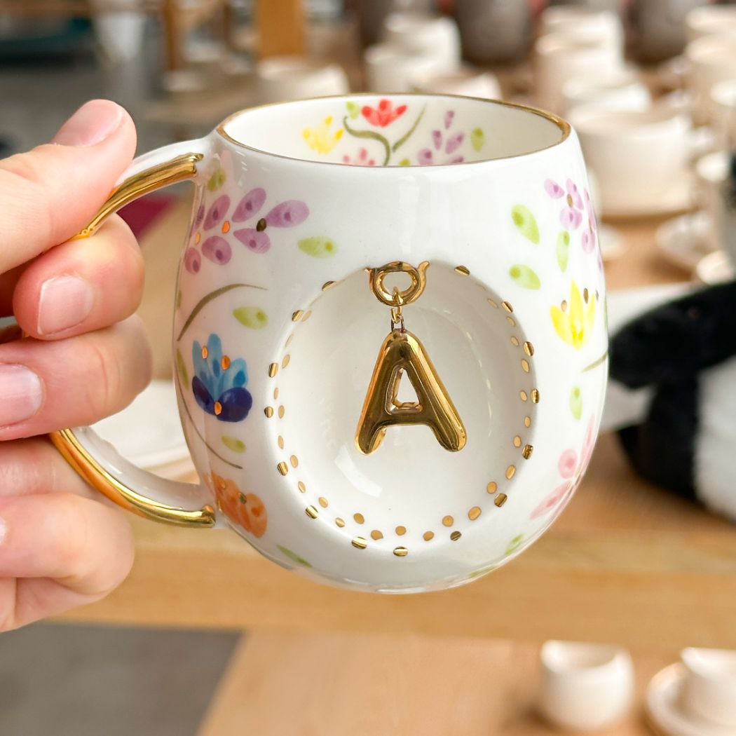 Porcelain letter mug with gold handle and gold letter A, spring floral pattern
