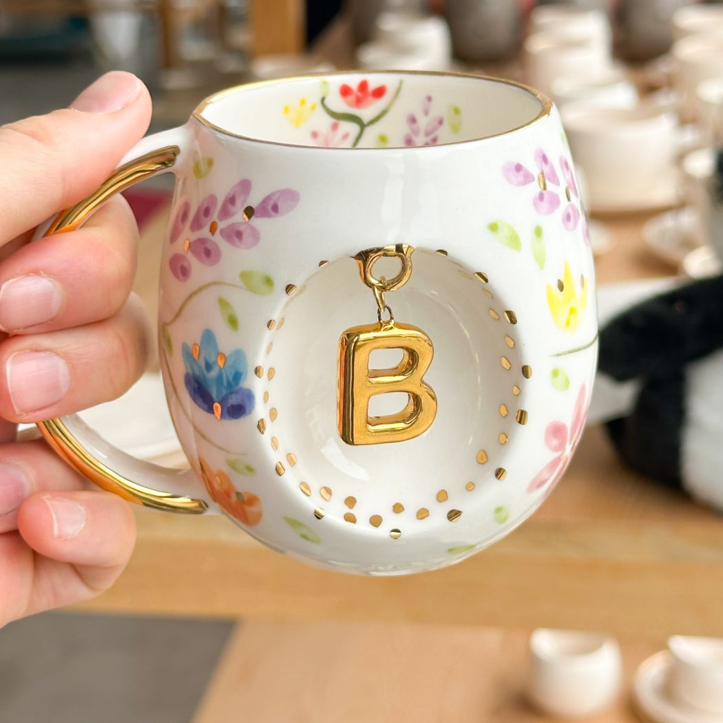 Porcelain letter mug with gold handle and gold letter B, spring floral pattern