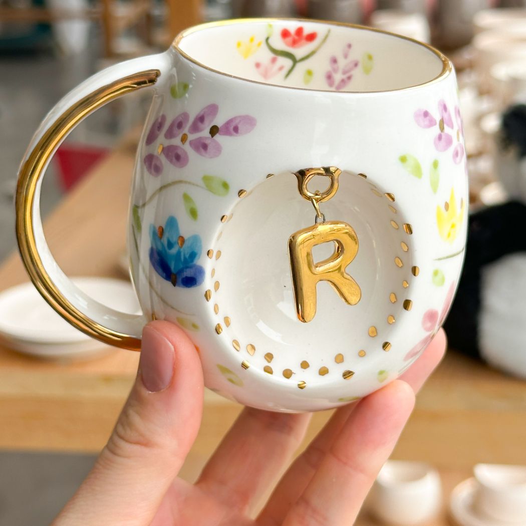 Porcelain letter mug with gold handle and R letter charm, floral spring blossom design