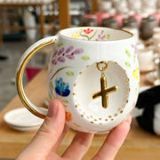 Porcelain letter mug with gold handle and spring floral design, featuring gold letter charm