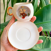 White deer coffee cup and saucer, gold handle and inner reindeer illustration