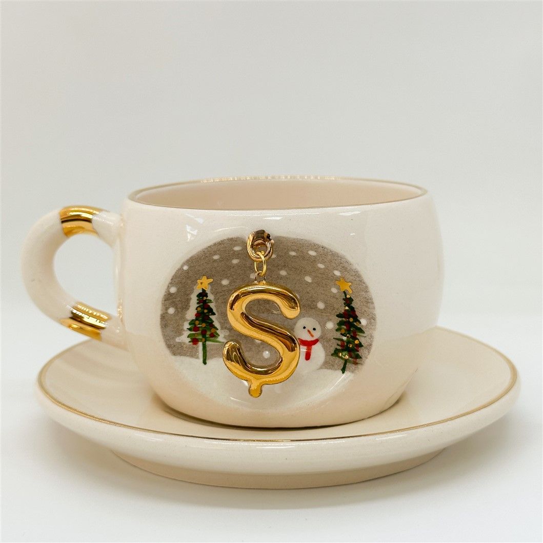 Porcelain tea cup and saucer, gold handle, letter S charm with trees and snowman