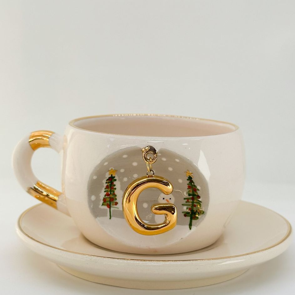 Porcelain tea cup on saucer with G letter gold charm, winter trees and dotted motif