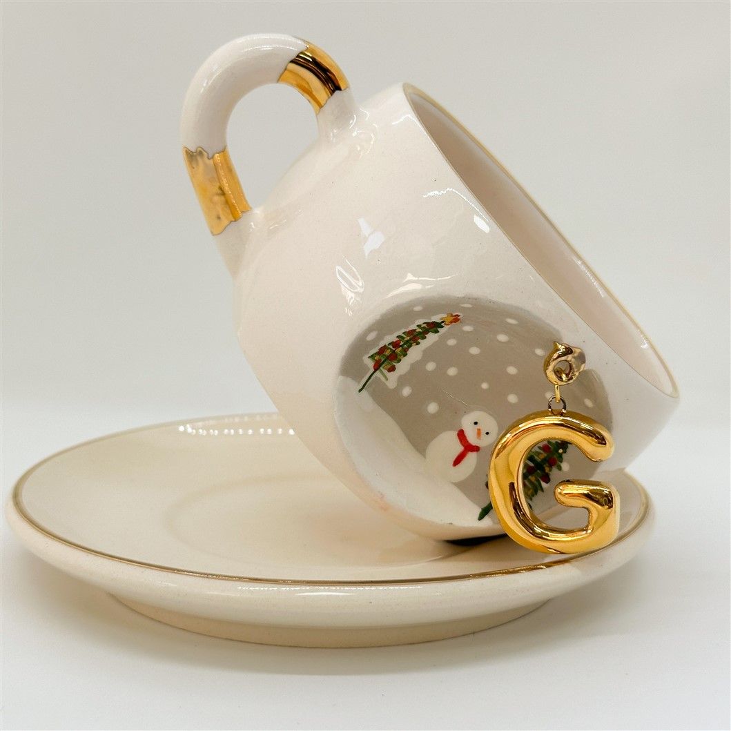 Porcelain tea cup on saucer with C letter gold charm, winter trees and snowman