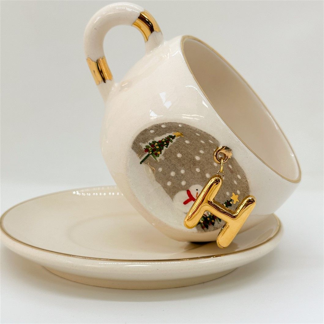 Porcelain tea cup and saucer set, white with gold letter charm and winter tree scene