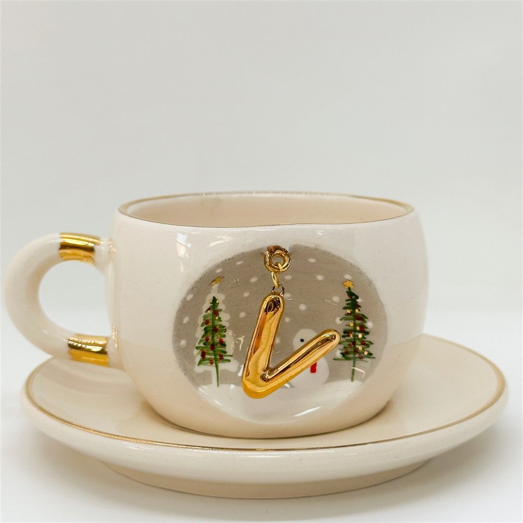 Porcelain tea cup and saucer, white with gold letter design, trees and snowman, 160 ml.