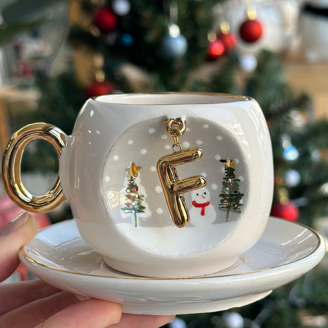 Porcelain coffee cup and saucer with gold letter Z charm, snowman and Christmas trees.