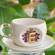 White ceramic mug and saucer set with purple lotus and gold letter B charm