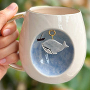 Blue whale ceramic mug with whale graphic charm and gold loop handle