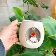 White mug with gold handle, Father Christmas scene printed inside circular backdrop