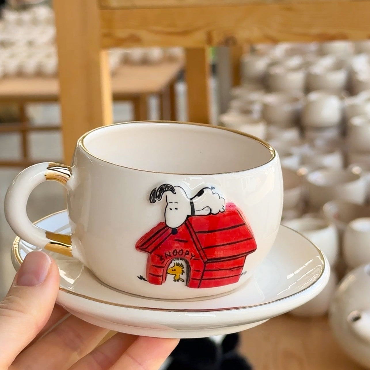 Ceramic Snoopy tea mug and saucer set, white with Snoopy in red-striped doghouse
