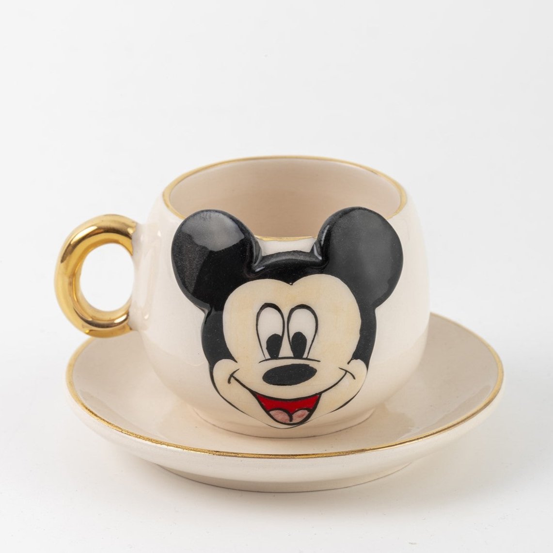 White Mickey Mouse coffee cup and saucer set, gold trim, character front