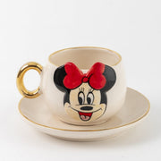 White Minnie Mouse coffee cup with gold handle, gold rim, and matching saucer