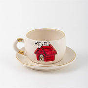 White ceramic Snoopy tea mug and saucer set, red-striped doghouse illustration