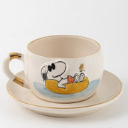White ceramic Snoopy tea mug and saucer set, yellow boat scene with blue waves