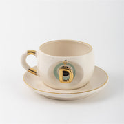 Cream tea mug set with gold letter D charm and saucer, Nile green accents
