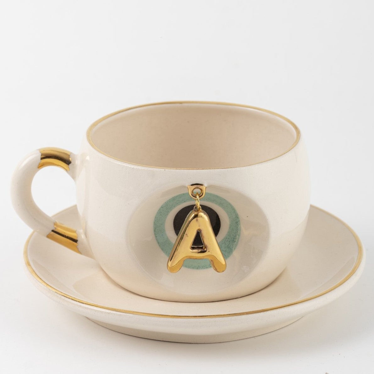 Cream tea mug set with gold letter A charm and saucer, Nile green accents