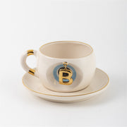 Tea mug with saucer, white ceramic, gold trim, blue medallion letter B