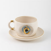 Tea mug with saucer, white ceramic, gold trim, blue medallion letter C