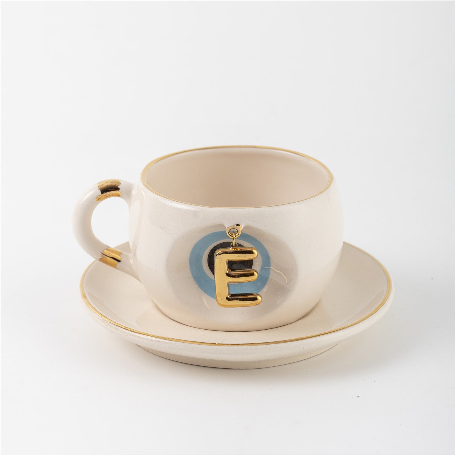 Tea mug with saucer, white ceramic, gold trim, blue medallion letter E