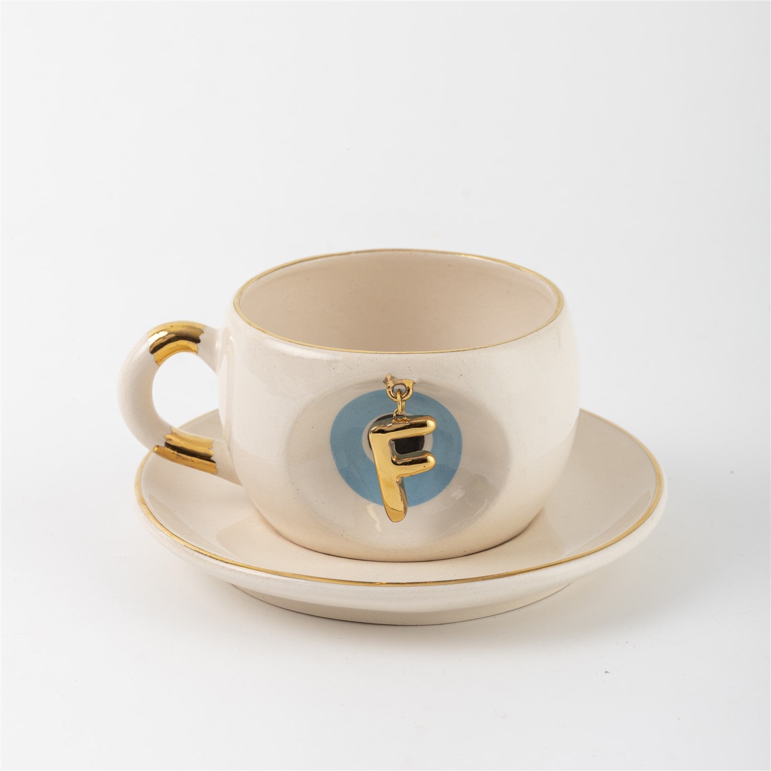 Tea mug with saucer, white ceramic, gold trim, blue medallion letter F
