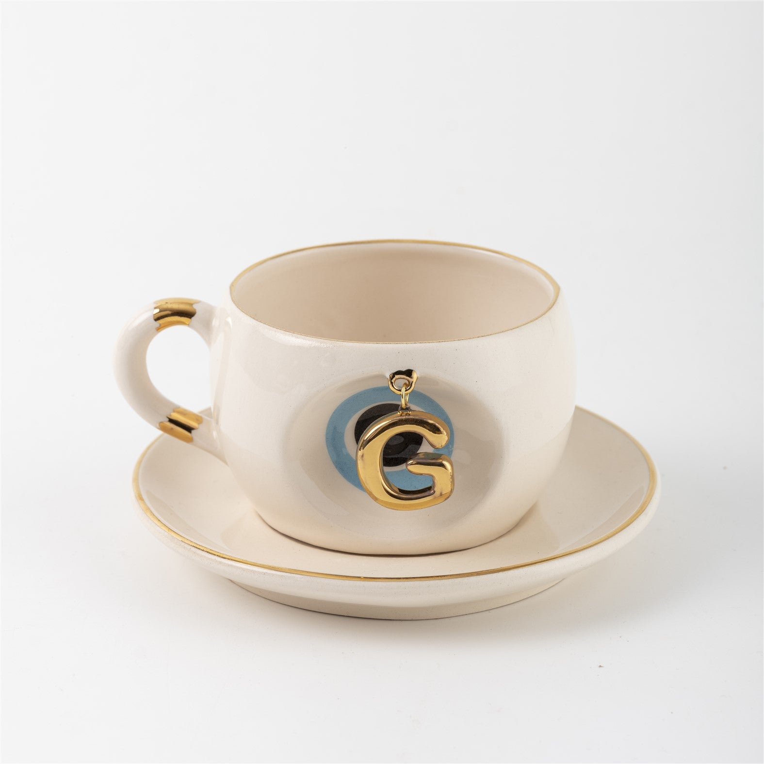 Tea mug with saucer, white ceramic, gold trim, blue medallion letter G