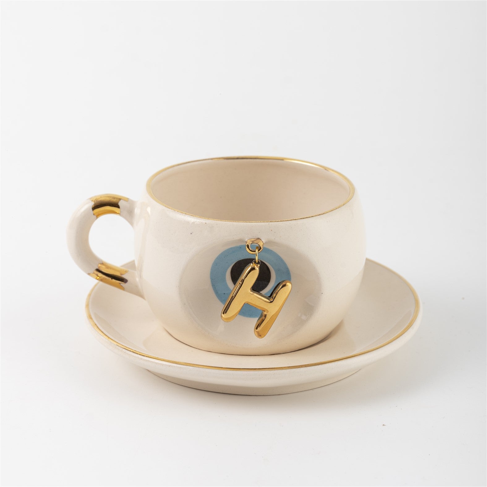 Tea mug with saucer, white ceramic, gold trim, blue medallion letter H