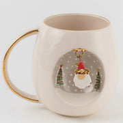 White ceramic mug with gold handle, Father Christmas illustration inside a round scene