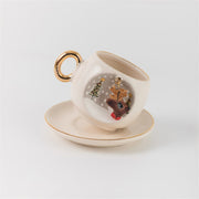 White deer coffee cup and saucer with gold handle, reindeer ornament graphic