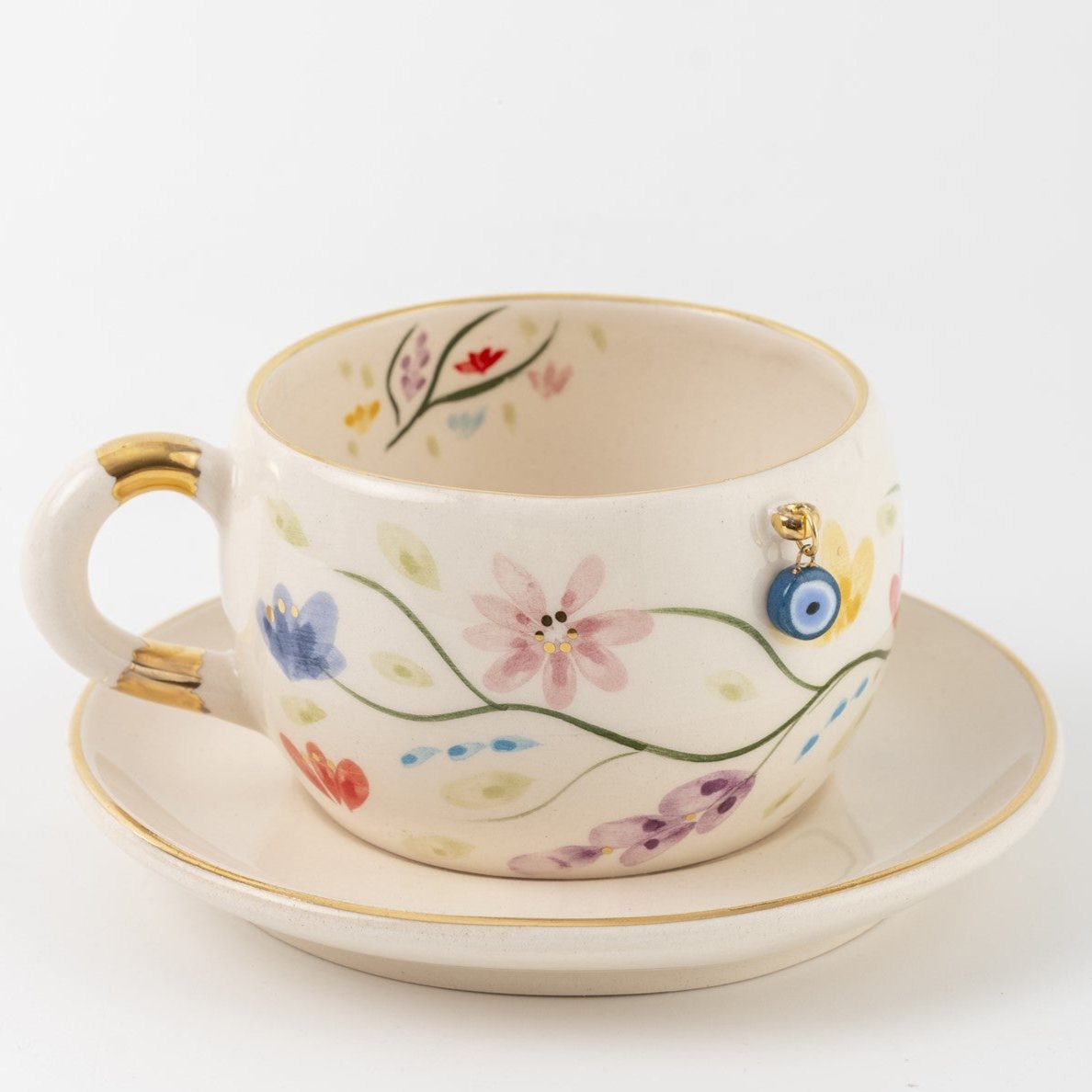 Tea cup and saucer set in white with multicolor flowers and gold trim