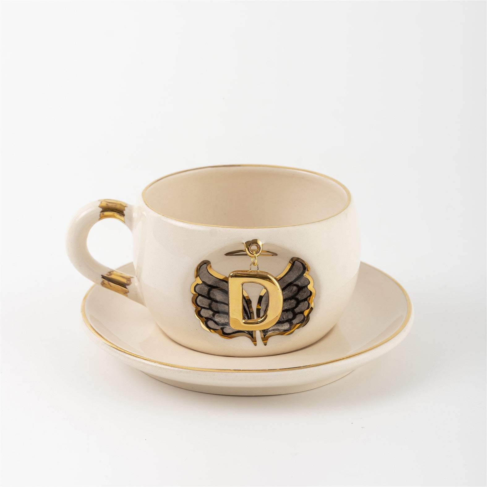 Porcelain mug and saucer with angel wing badge and gold letter V, cream base